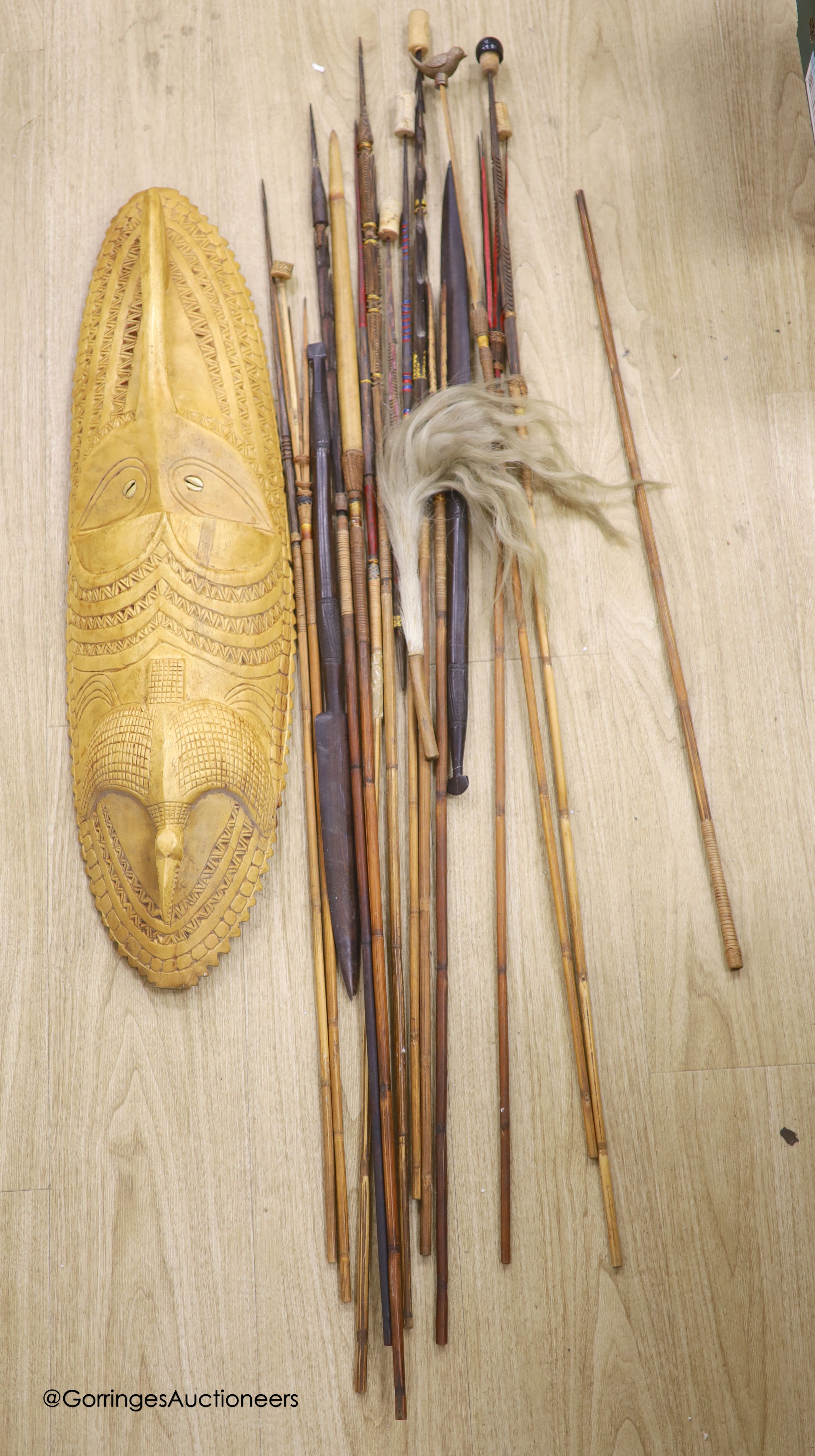 A collection of Tribal style spears etc and a mask
